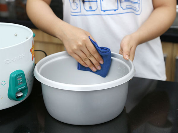 Use a clean cloth to gently wipe the inside of the small pot