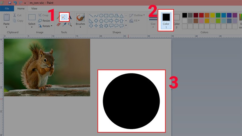 Nhấn vào biểu tượng thùng sơn > Chọn màu đen và tô màu cho hình tròn vừa vẽ