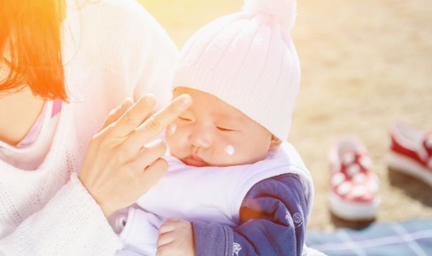 Nếu đi ra ngoài vào ngày nắng, mẹ có thể dùng kem chống nắng cho bé