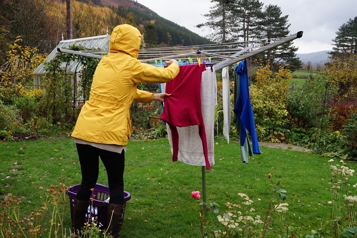 Should clothes that are being dried and get rained on be washed again to avoid the appearance of unpleasant odors and mold