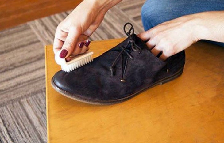 Sử dụng bàn chải di chuyển từ khu vực xung quanh rồi đến bên trong trên giày da lộn màu đen