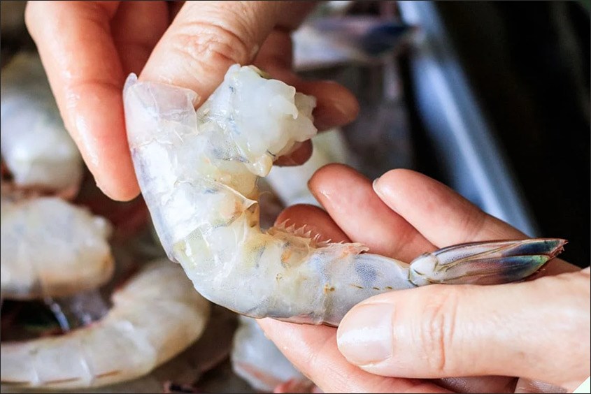 Tôm bỏ phần vỏ và ướp gia vị cháo tôm bí đỏ phô mai cho bé giàu dinh dưỡng