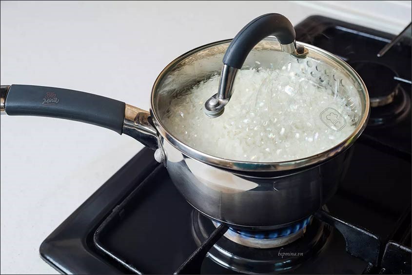 Vo gạo và cho lên bếp nấu nhừ cháo tôm bí đỏ phô mai cho bé thơm ngon