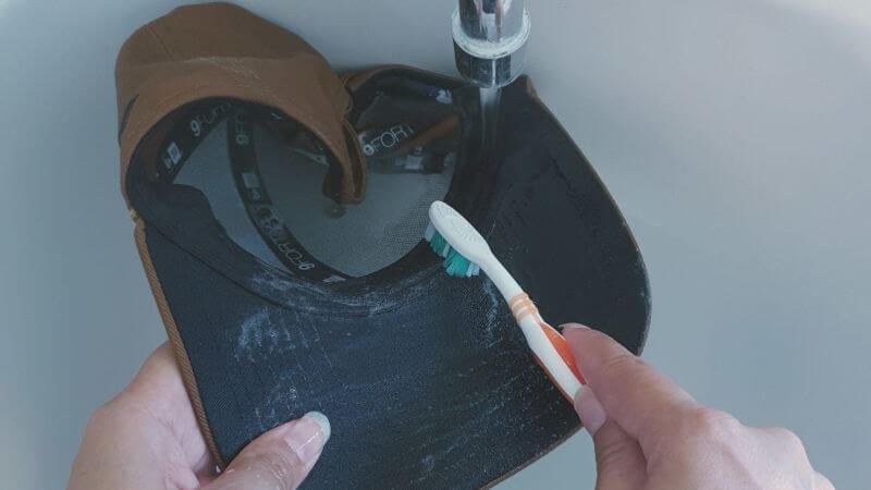 Giặt sạch mũ có thể giúp hạn chế tổn thương da dầu vào mùa mưa