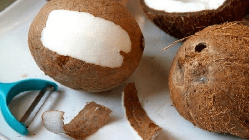 Use a peeler to remove coconut shell
