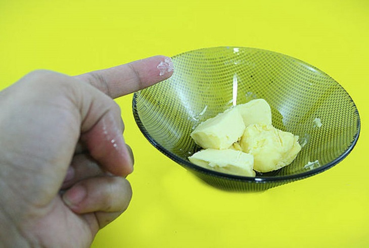 Using margarine will quickly soften the glue and you will be able to wash it off with water