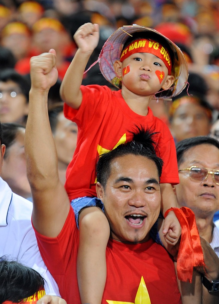 Young fans cheering for the Vietnam national team