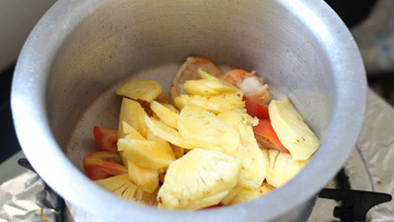 Cho thơm và cà chua vào, xào đến khi các nguyên liệu chín mềm.