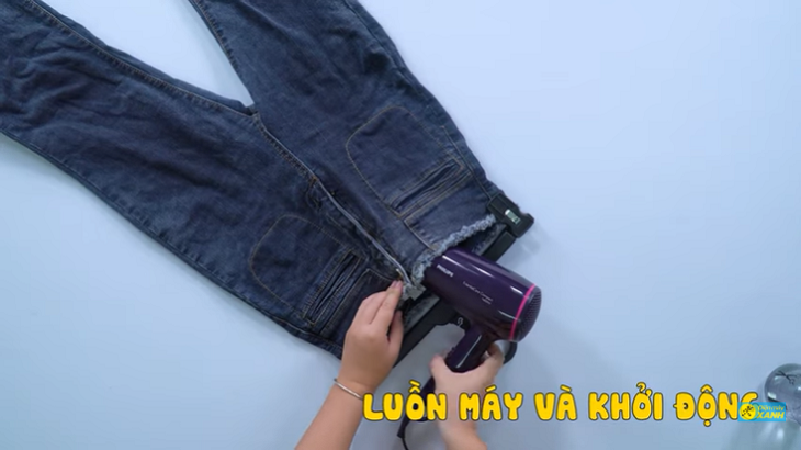 Thread the hairdryer inside the jeans and start the machine
