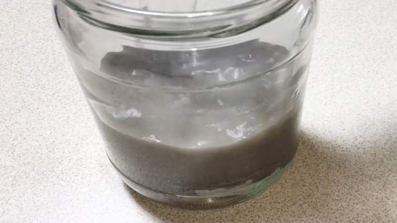 Put ash water into a container and cover it for 2 days