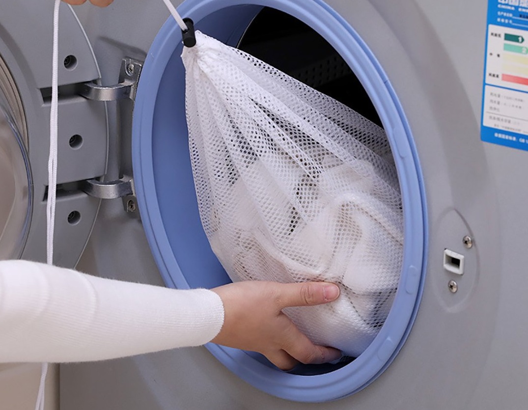 Close all locks and fasten buttons then put the clothes in a special washing bag and select the washing mode