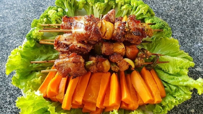 Delicious grilled skewered meat with mixed vegetables