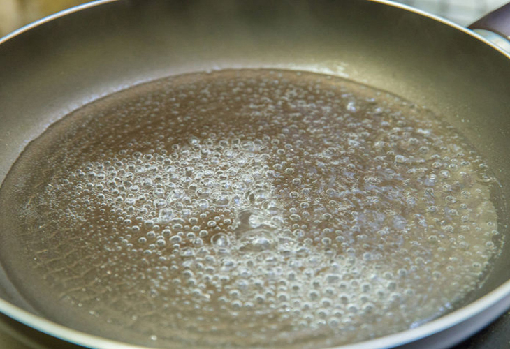 Soak the pan in hot water and dishwashing liquid