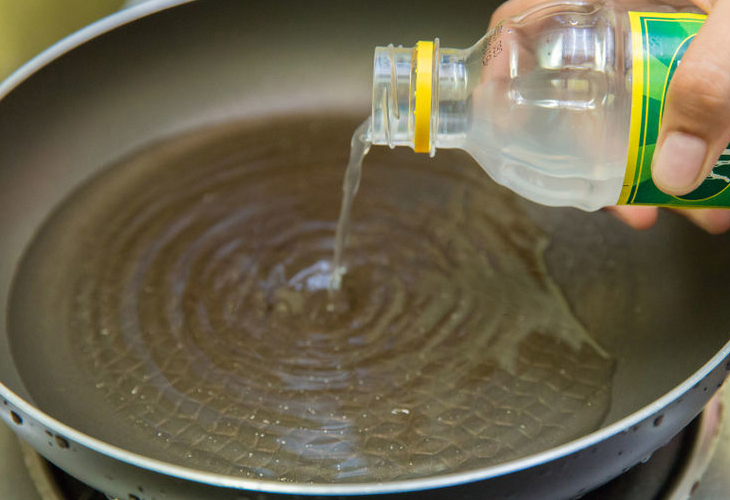 Boil the pan with vinegar to clean it
