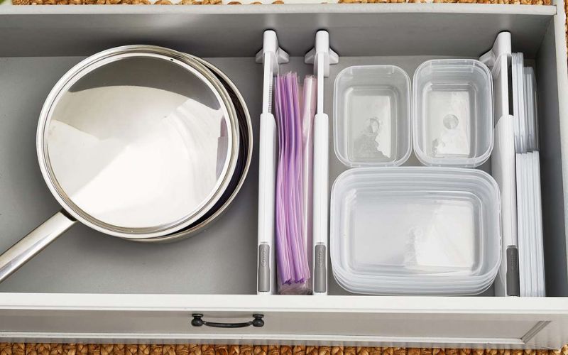 Use tension rods in cabinet drawers