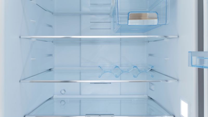 Image of removing the shelves from the inside of a refrigerator