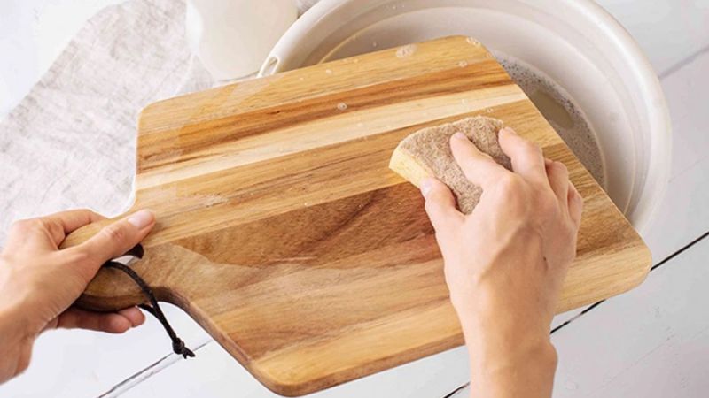 You should use boiled water or saltwater to clean the cutting board