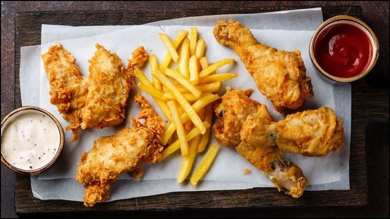 Trong thời kỳ kinh nguyệt, tránh những thực phẩm mà gây khó tiêu như khoai tây chiên, đùi gà chiên, xúc xích...